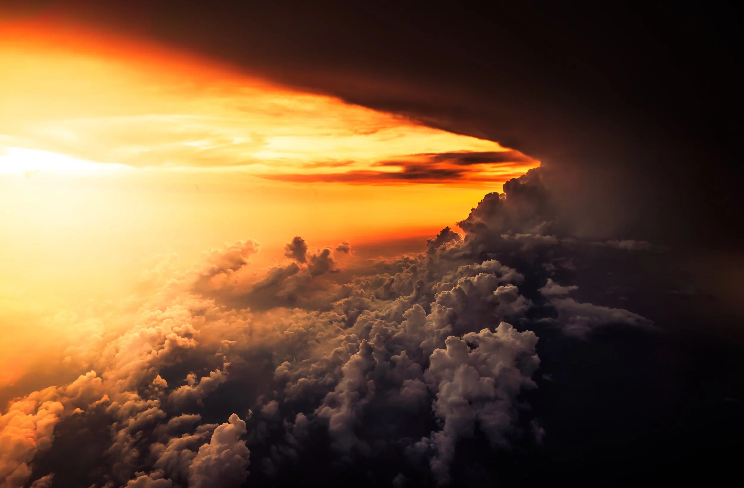 Sunlight opening through a sweeping bank of clouds